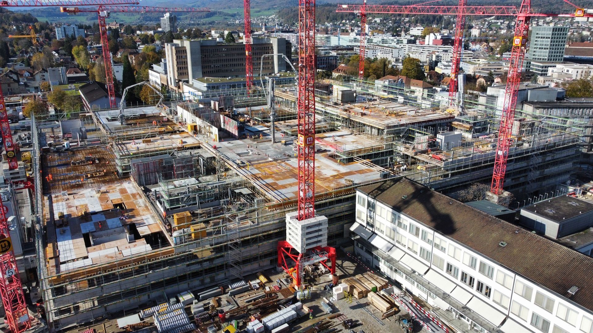 Drohnenaufnahme einer grossen Baustelle mit mehreren Kranen